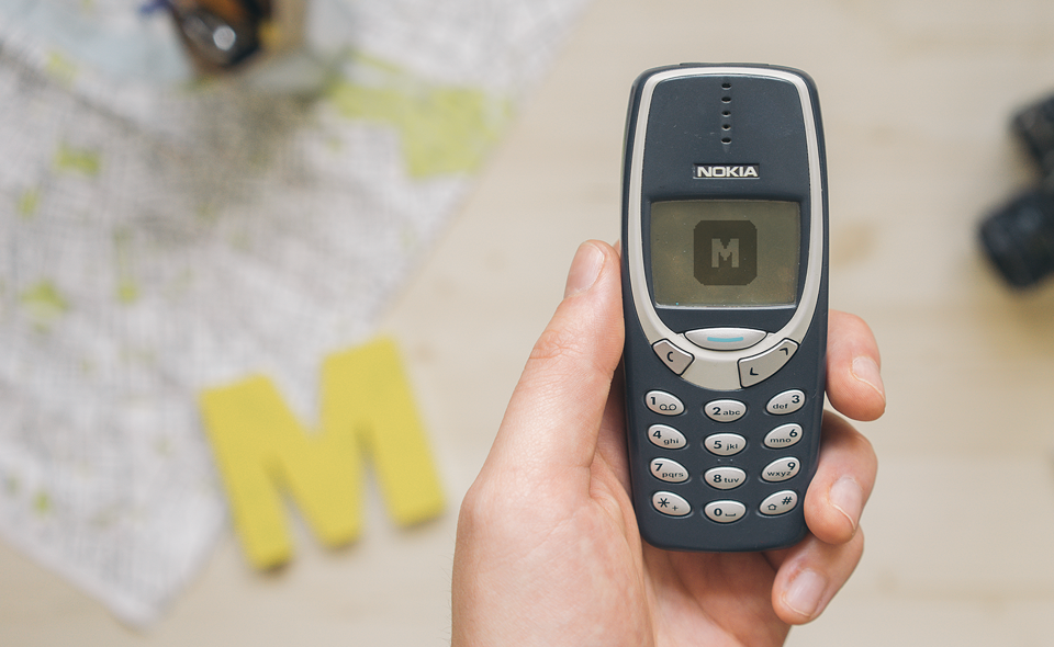 Free mockup of Nokia 3310 held by one hand