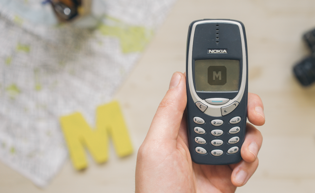 Free mockup of Nokia 3310 held by one hand
