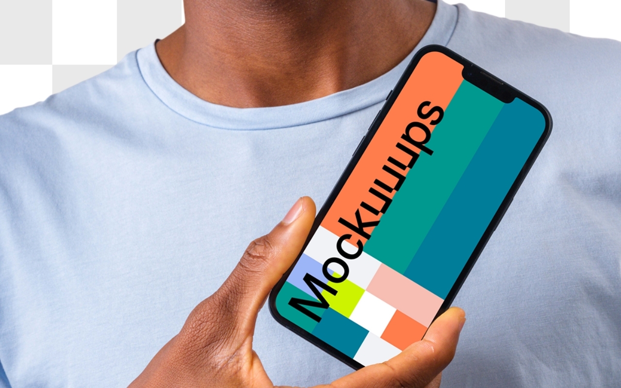 African-American man in light blue t-shirt holding iPhone mockup on transparent background from device mockup generator