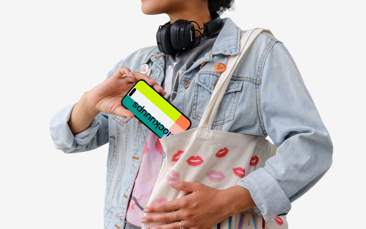 Female student holding iPhone mockup with transparent background, focused on device screen for design projects