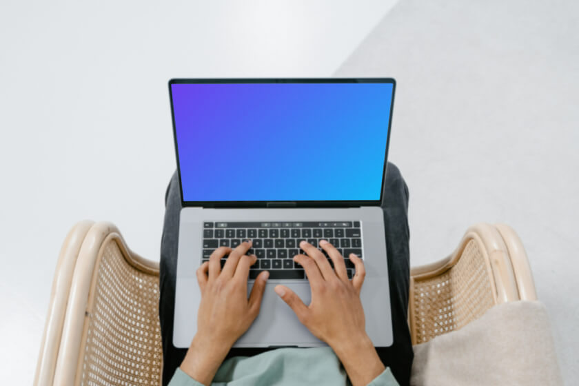 User typing on MacBook Mockup