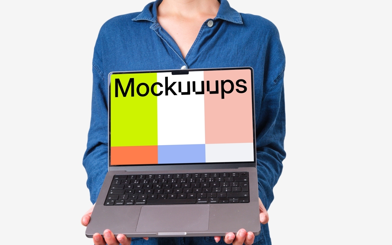 MacBook Pro mockup showing woman with short hair in denim shirt holding laptop device on transparent background