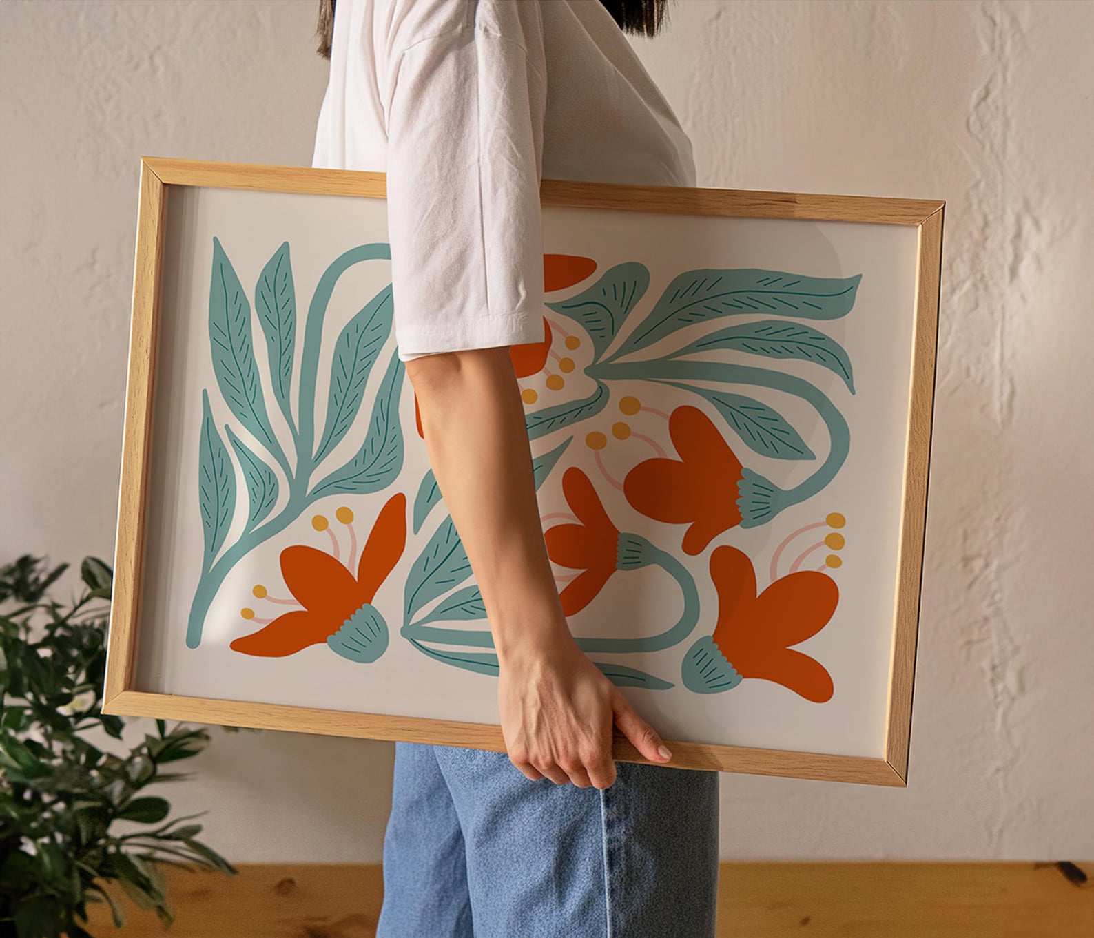 Casually held natural wooden frame in cozy, minimalist home with lush green leaves; best poster mockups for serene design.