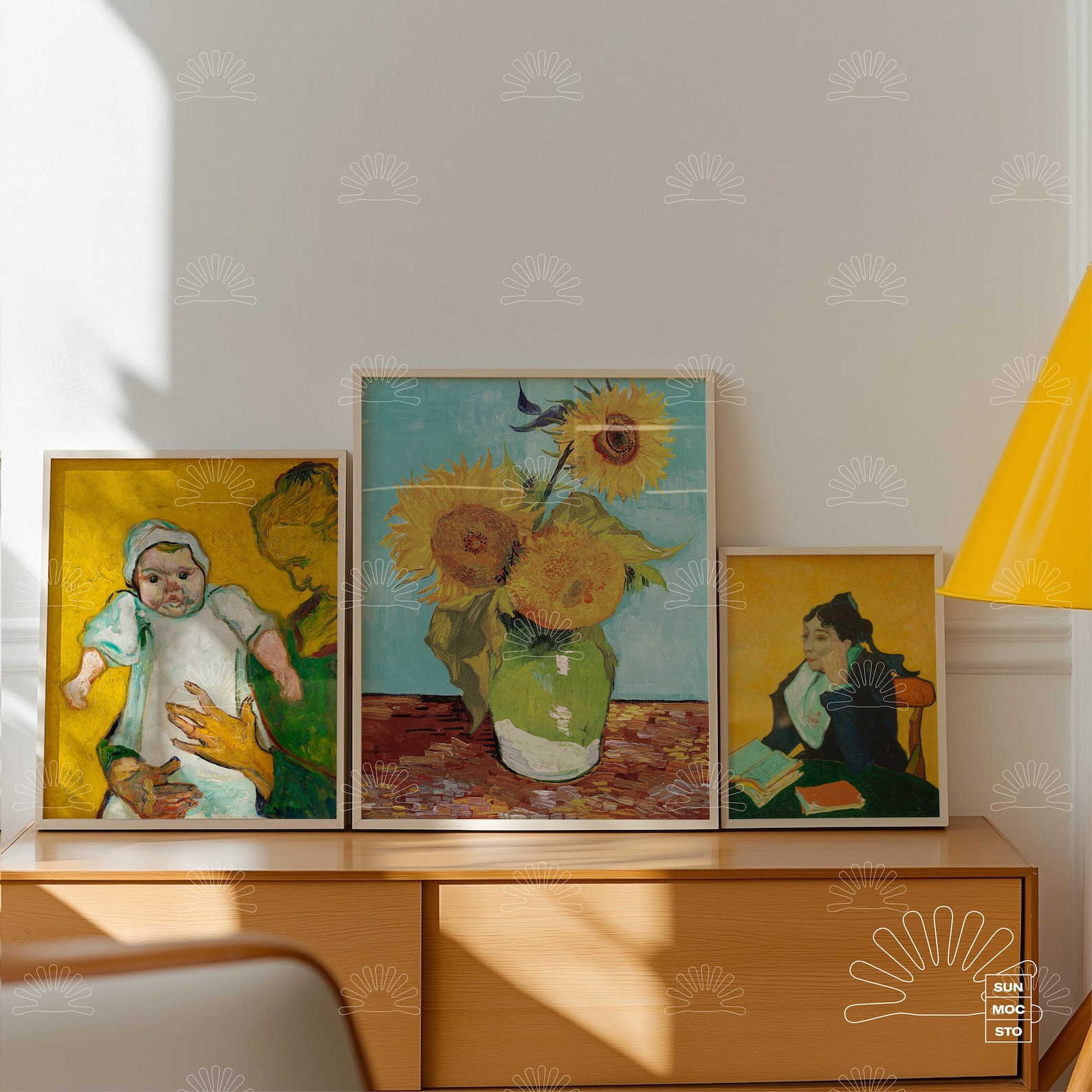 Framed artworks on a wooden sideboard with a yellow lamp; ideal for the best poster mockups in a serene designer setting.
