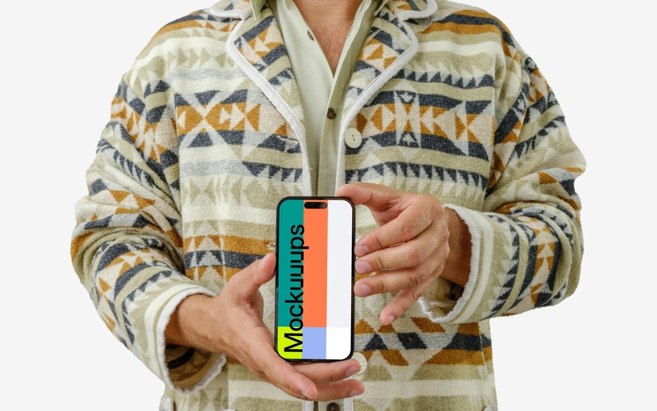 Man holding iPhone mockup in hand wearing textured sweater on transparent background for device mockup generator