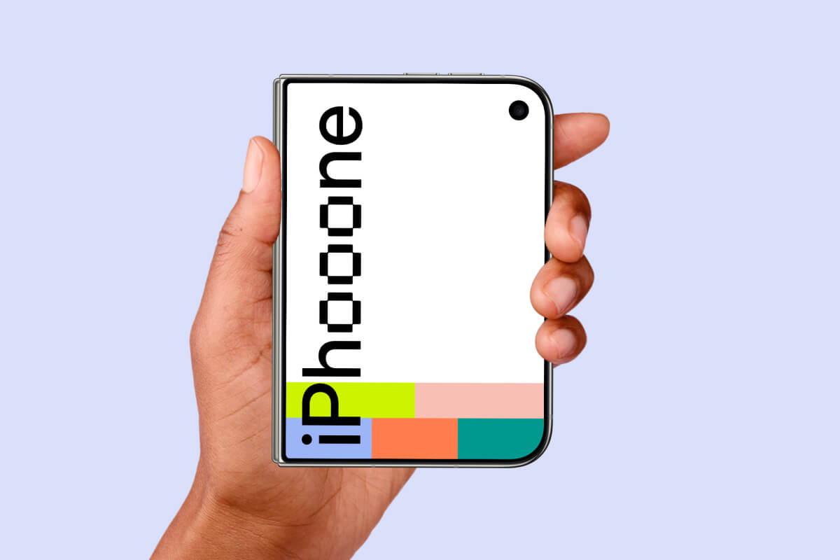 Right hand holding a closed iPhone Duo by the edges, pale lavender backdrop