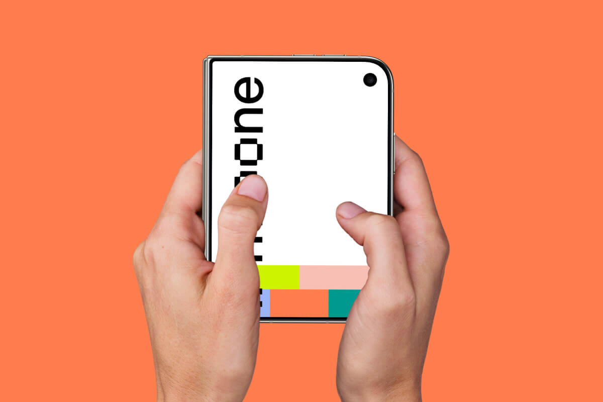 Two thumbs resting on a closed iPhone Duo against a solid orange field