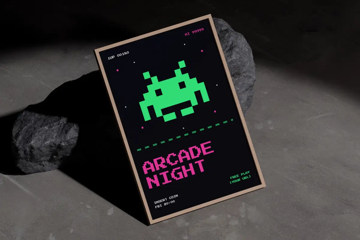 A3 poster in a wooden frame on a concrete floor, propped up against two dark rocks