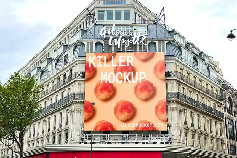 Large billboard mockup on the facade of a historic Parisian department store