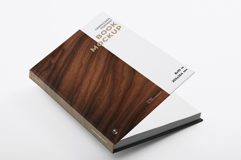 Open hardcover book with wood-like texture on a white surface