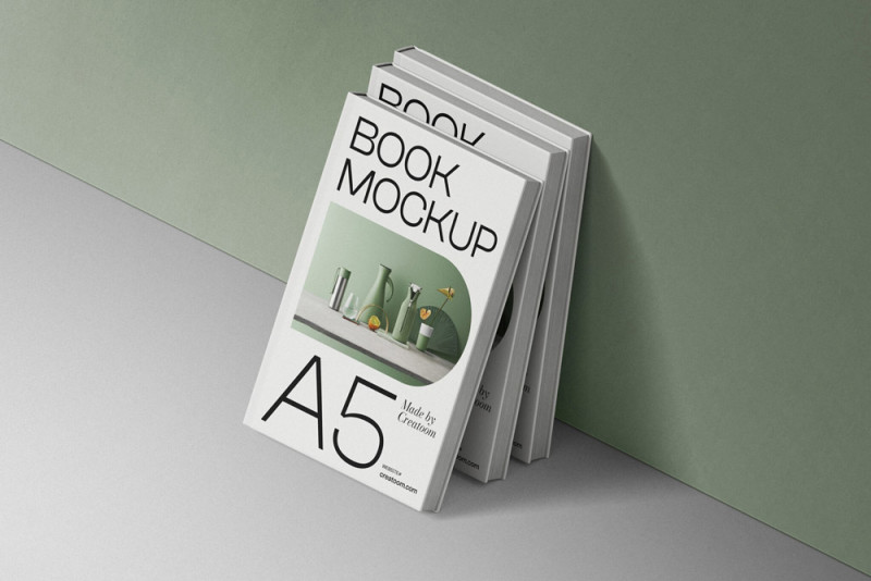 A5 book mockup stack on a green and gray backdrop.