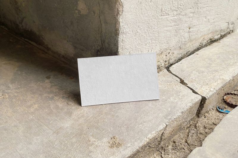 Blank card leaning against a concrete wall, ideal for best EU business card mockups showcasing.