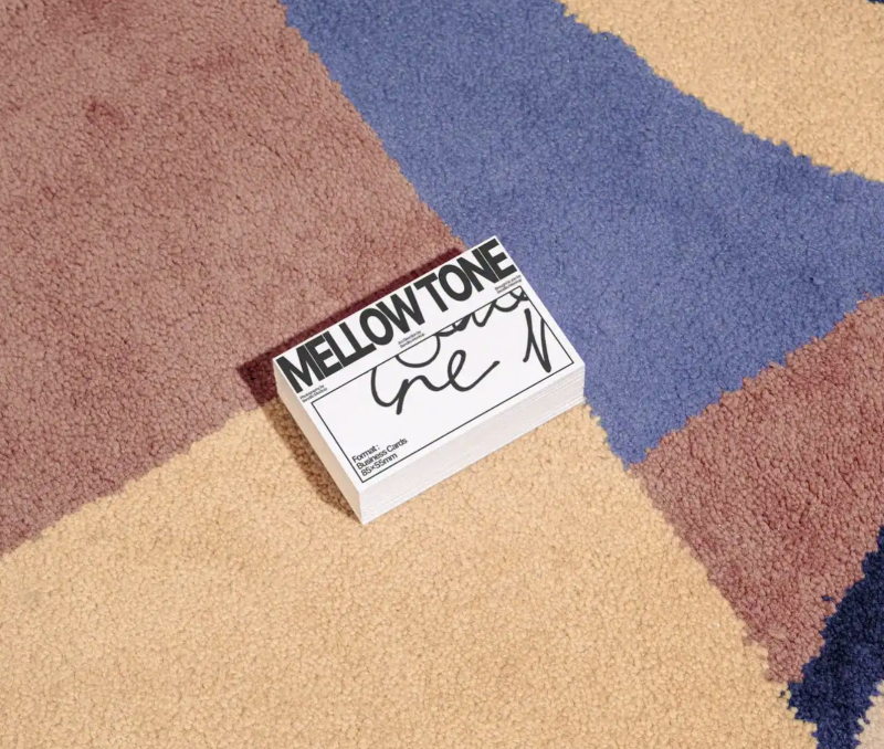 Stacked business cards mockup on a textured rug. Best EU business card mockups showcase design and texture.