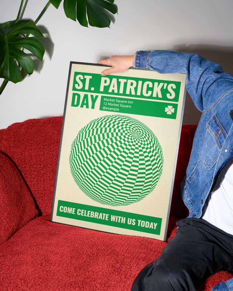 A vibrant free poster mockup in a cozy setting with a red couch and denim jacket, surrounded by lush greenery.