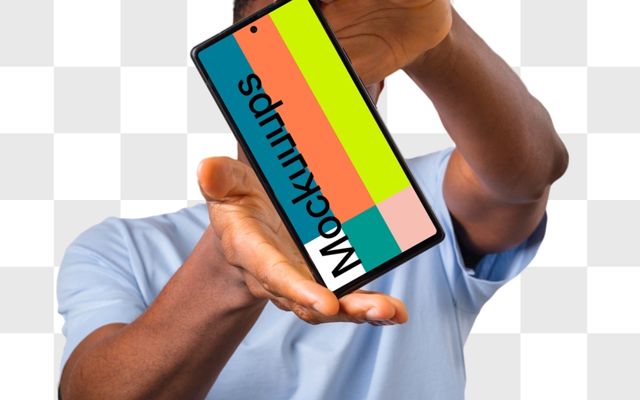 Young African-American man holding Google Pixel mockup in light blue shirt on white background, device mockup template
